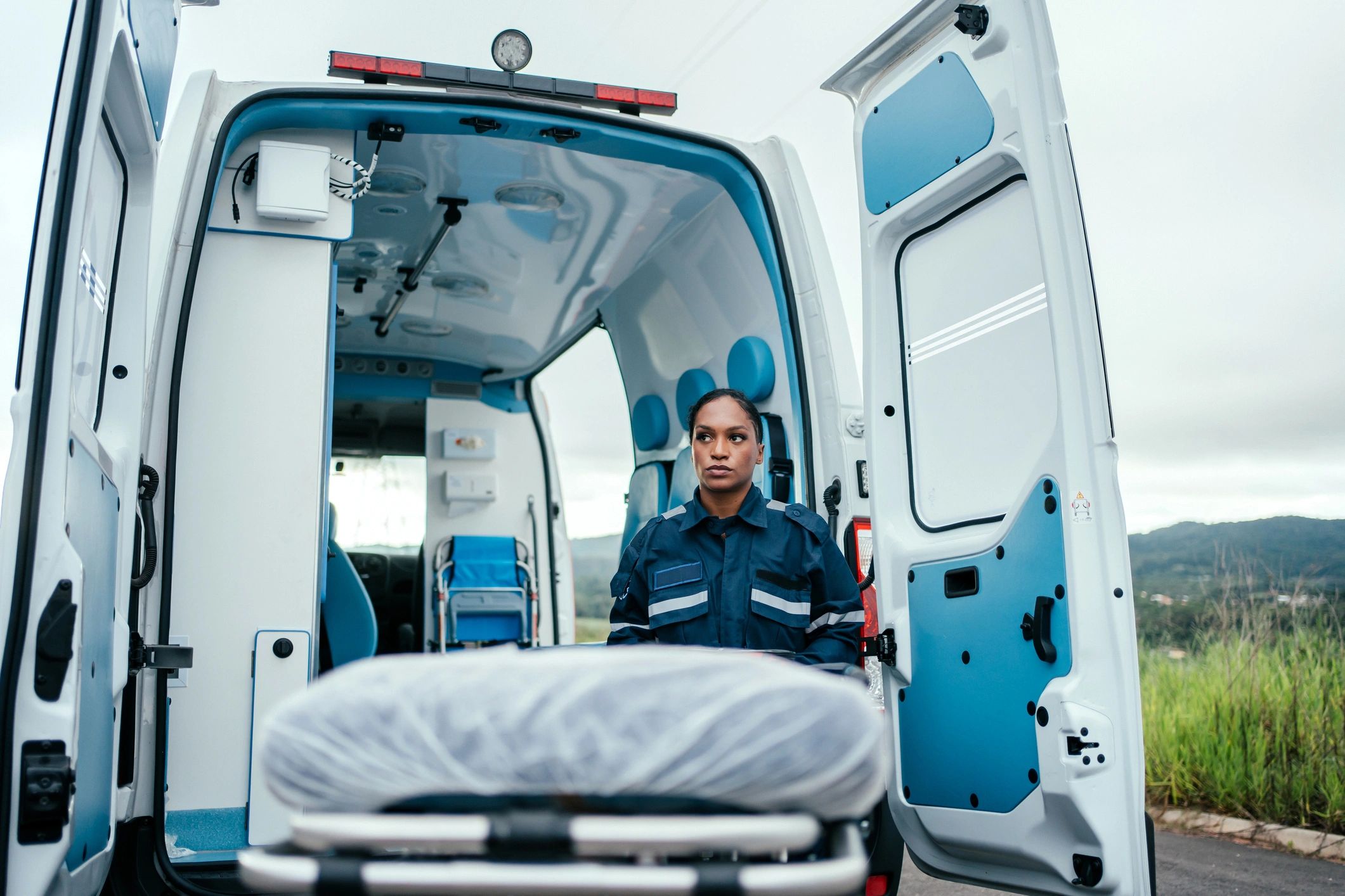 Paramedic with a stretcher preparing for patient transport