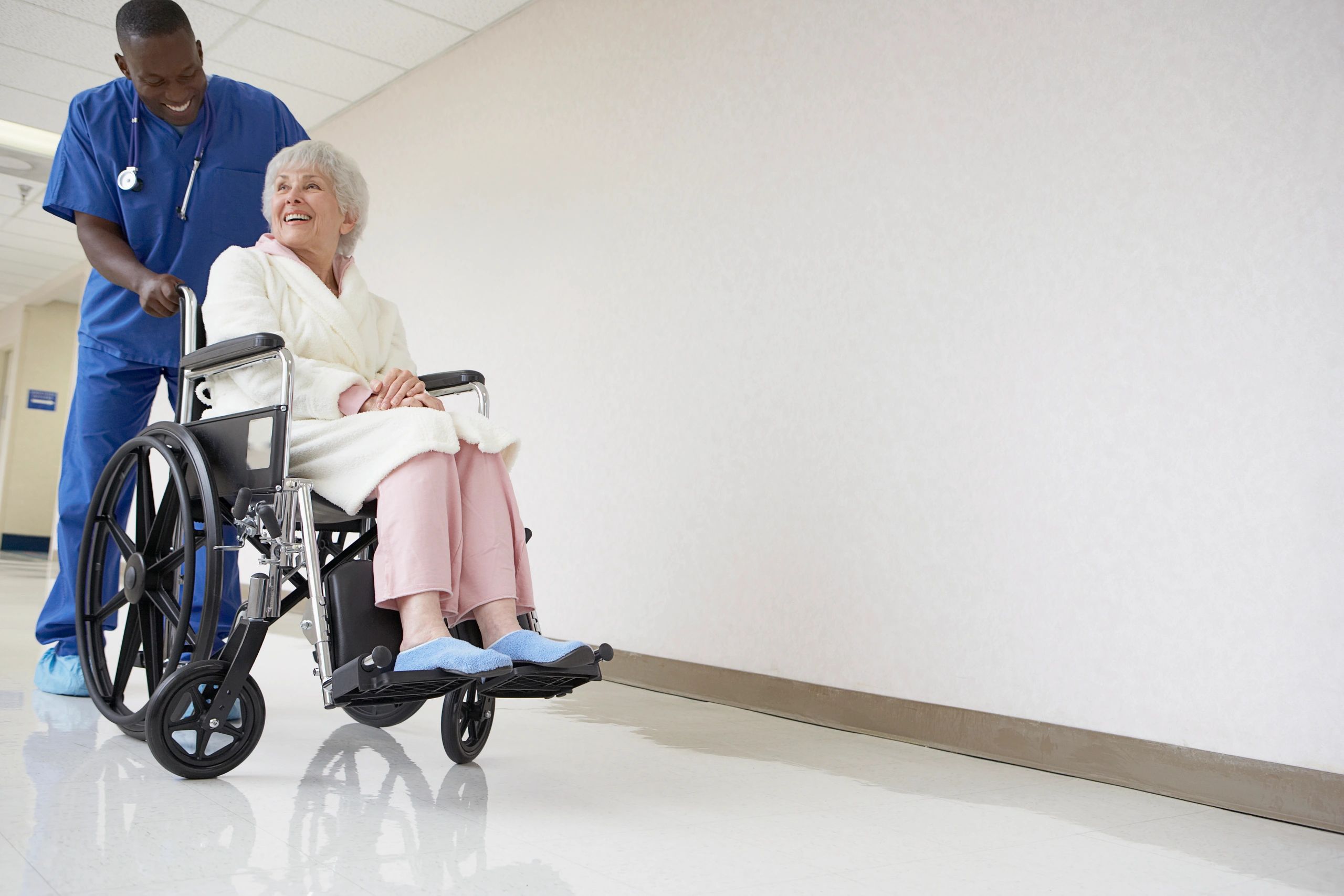 Nurse pushing a patient in a wheelchair