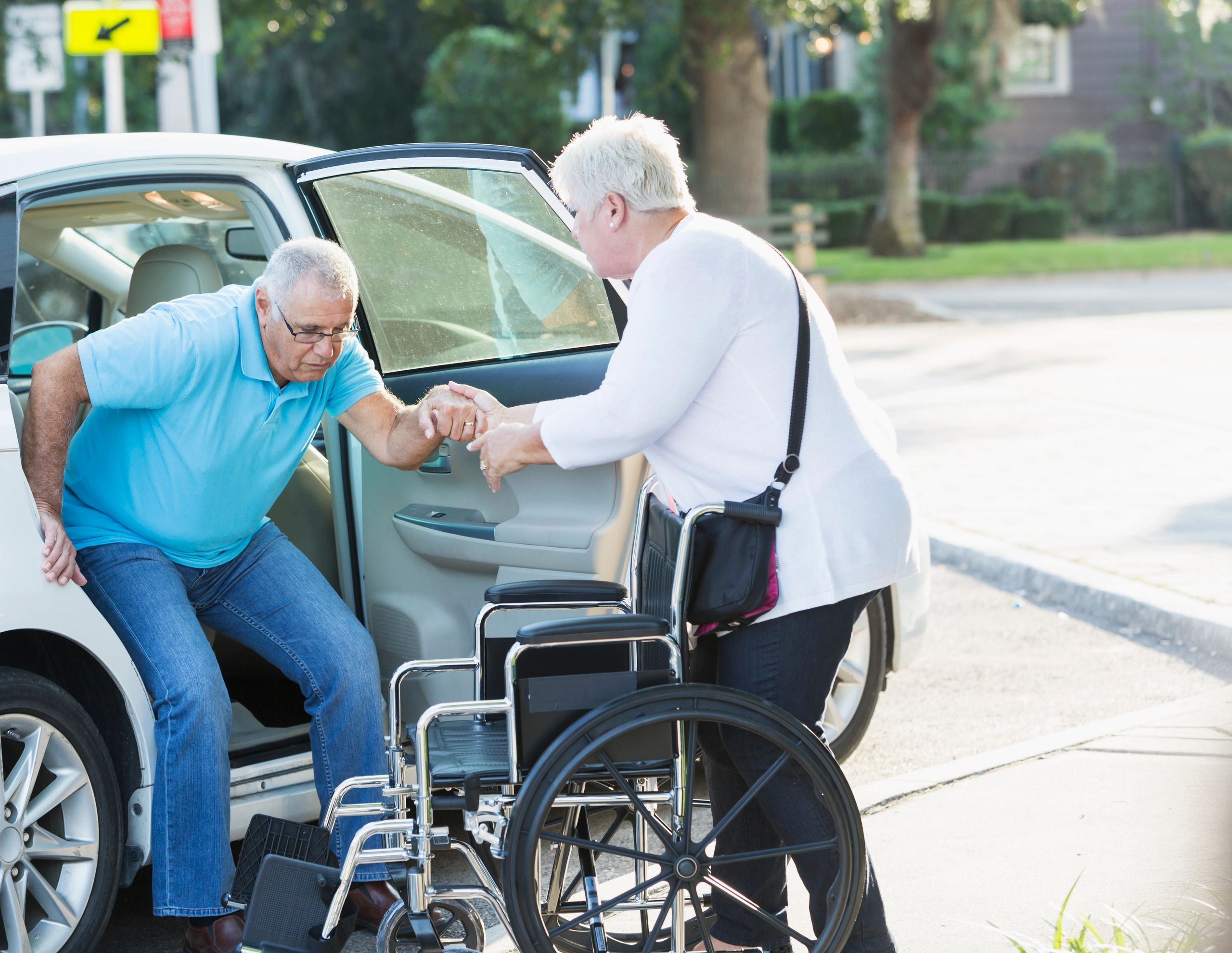 Senior couple with wheelchair assistance